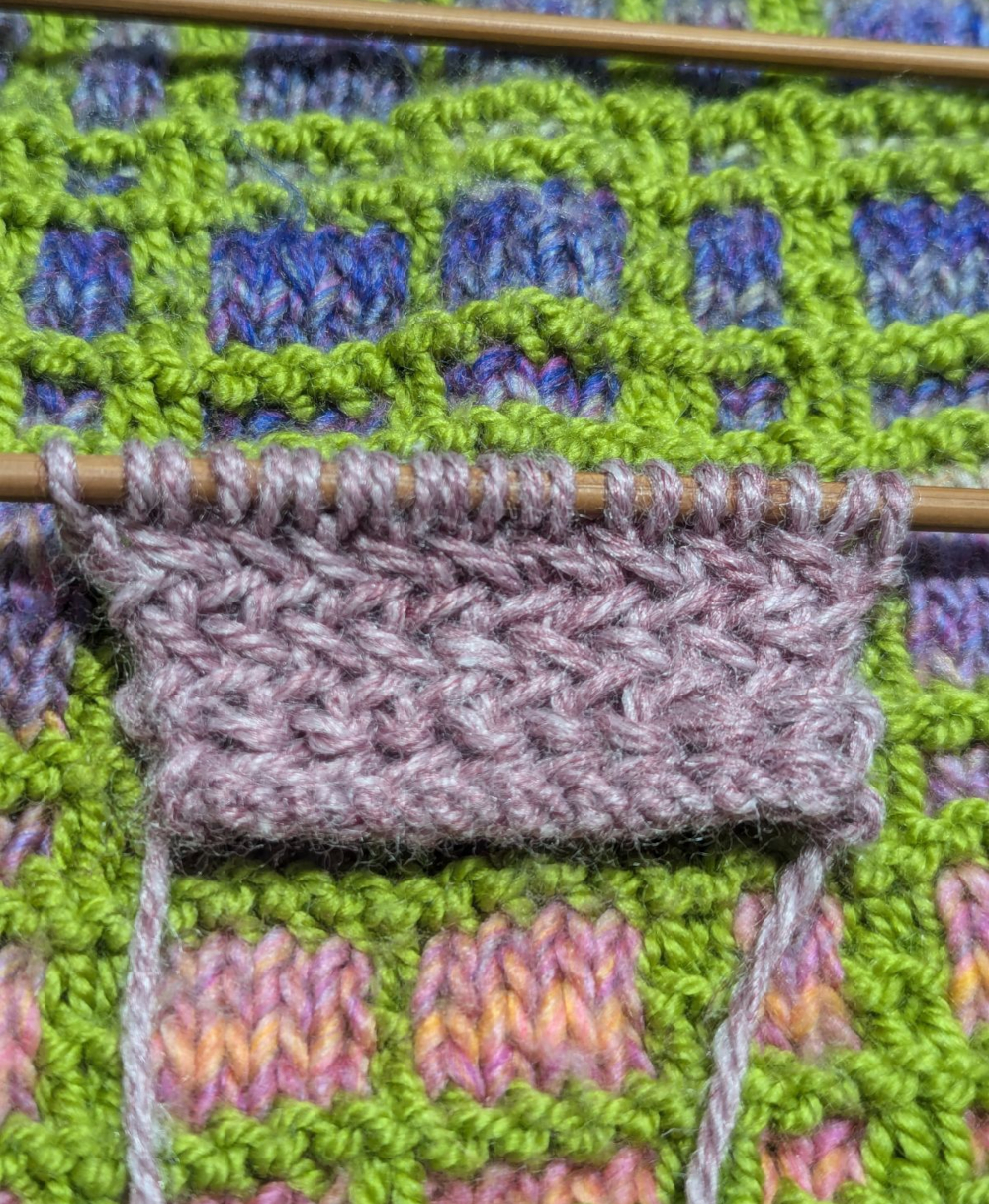 herringbone stitch sample against mosaic plaid scarf/shawl